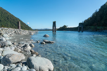 The beautiful  blue water of the Whataroa river in the Franz Josef area heading for the Southern...