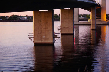 concrete pillars on underside of bridge over river