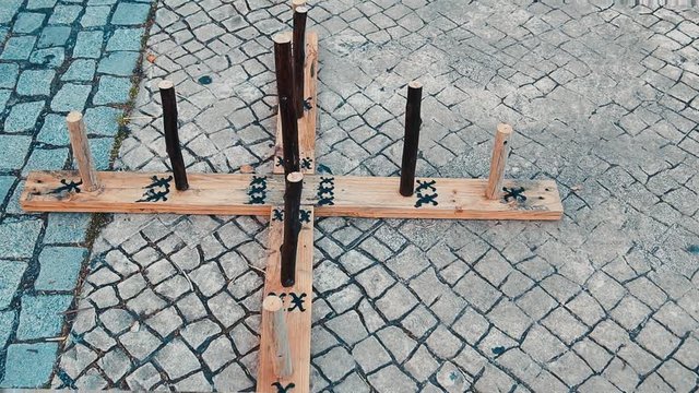 Medieval outdoor entertainment wooden game middle ages involves the throwing of metal, rope or rubber rings over a set distance, usually to land over or near a spike called a hob, mott or pin