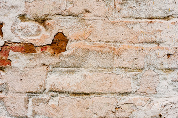 Texture of a brick wall with cracks and scratches which can be used as a background