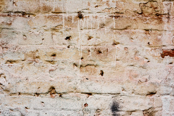 Texture of a brick wall with cracks and scratches which can be used as a background