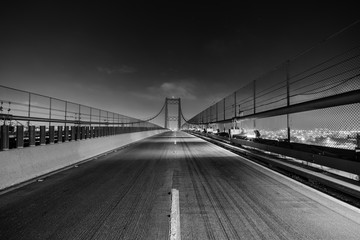Black and white night view of the Vincent Thomas Bridge in Los Angeles, California.  