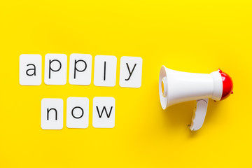 announce with apply now copy and megaphone on yellow background top view