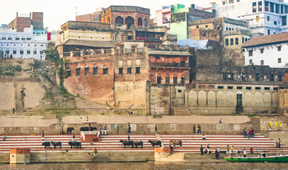 Stunning view of the Varanasi city with colored houses and buildings over a Ghat bathed by the...