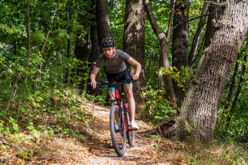 Fototapeta na wymiar Young man biking in forest