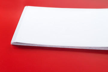 Stack of blank name cards, white empty business card, poster or flyer on red texture. Blank signboard with copy space area for text or slogan
