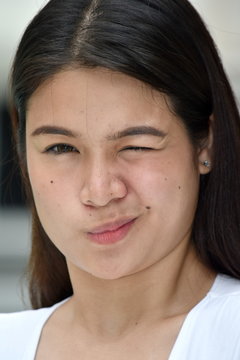 A Young Filipina Female Winking