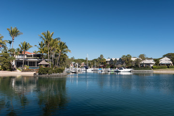 Fototapeta na wymiar A waterside residential area in Coolangatta with personal moorings for boats. Gold Coast, Queensland, Australia.