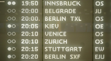 Obraz premium Modern plane departures board with detail on European city destinations typed in illuminated letters at Schwechat airport