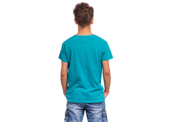 Fototapeta premium T-shirt design concept. Teen boy in blank blue T-shirt, isolated on white background - back view. Mock up template for print. Child with hands in pockets - rear view.