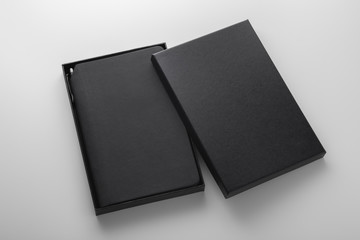 Black notebook, pu leather cover, in box with pen holder, mockup on grey background, business gift