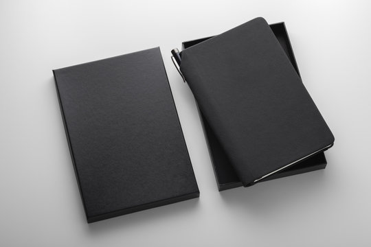 Black pu leather notebook in box with pen holder, mockup on grey background, business gift