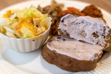 bread, salad, egg with mushroom for breakfast
