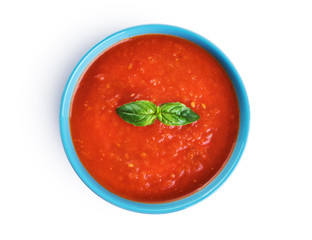 Bowl of tomato soup isolated on a white background.