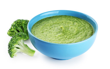 Bowl of green cream soup with pea, broccoli, kale and spinach  isolated on white background.