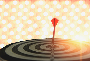 Dart with arrows on the bokeh blur background comparing to the number one target marketing concept and success.