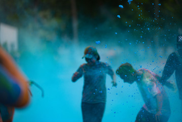Fototapeta na wymiar Ho Chi Minh City/ Vietnam - September 2017: Royalty high quality free stock photo of unidentified people are attending jogging festival with color powder. Color run event.
