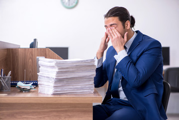 Young handsome businessman working in the office