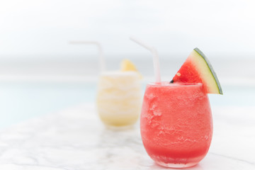 Fresh watermelon juice and pineapple juice on mable table in the beach.