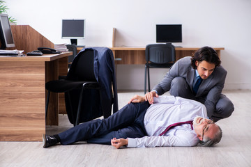 Male employee suffering from heart attack in the office