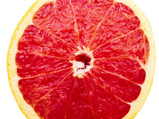 cut in half red grapefruit close up on white background