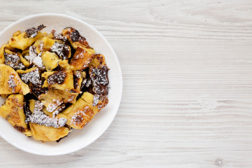 Homemade german Kaiserschmarrn pancake on a white wooden background, top view. Flat lay, overhead, from above. Space for text.