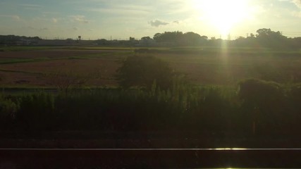 Japan Railway train window. Rural landscape in the evening