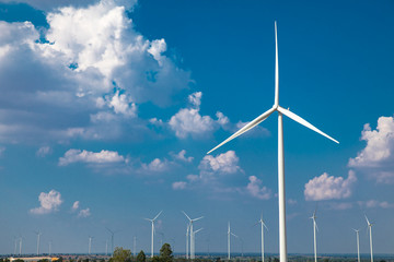 green meadow with Wind turbines generating electricity