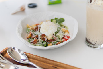 Cesar Salad with egg for breakfast in the restaurant.