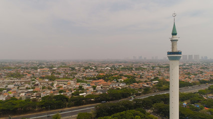 Obraz premium aerial view minaret mosque Al Akbar against city Surabaya highway, skyscrapers, buildings and houses. mosque in Indonesia Al Akbar in Surabaya, Indonesia. beautiful mosque with minarets on island Java