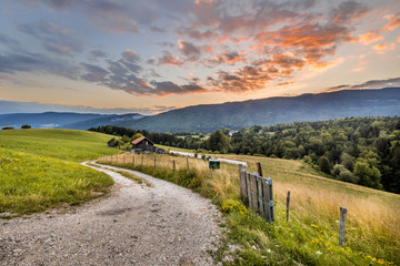 Rural road in mountain landscape in French Alps