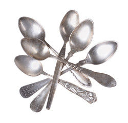 top view of shiny old vintage silver empty spoons on an isolated white background
