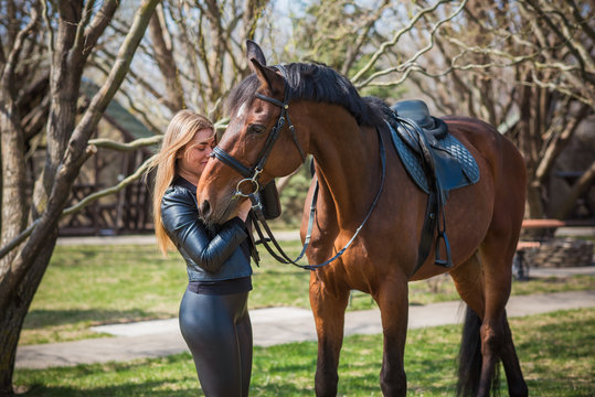Hobby concept, woman with a horse on a horse farm. Human and animals friendship 