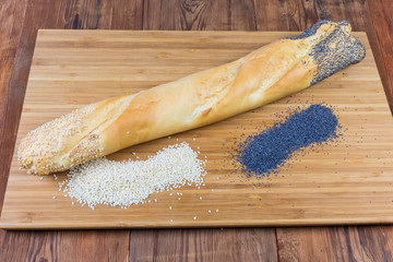 Baguette sprinkled with whole sesame seeds and poppy seeds
