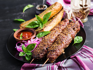 Kebab adana,  lamb and beef and toasts with pesto sauce.
