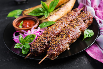 Kebab adana,  lamb and beef and toasts with pesto sauce.