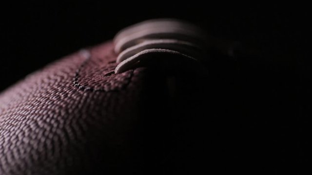 Darkened close up of American Football laces C