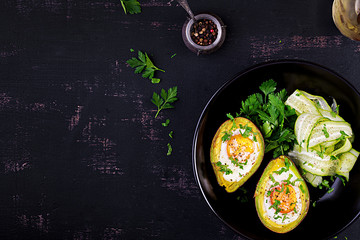 Avocado baked with egg and fresh salad. Vegetarian dish. Top view, overhead.  Ketogenic diet. Keto food