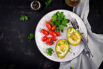 Avocado baked with egg and fresh salad. Vegetarian dish. Top view, overhead.  Ketogenic diet. Keto food