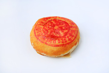 Traditional Chinese pastry or moon cake with lucky word printed on top isolated on white background.