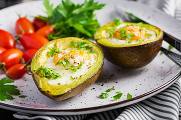 Avocado baked with egg and fresh salad. Vegetarian dish. Ketogenic diet. Keto food