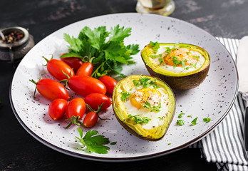 Avocado baked with egg and fresh salad. Vegetarian dish. Ketogenic diet. Keto food