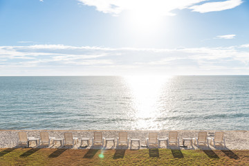 Obraz premium Beautiful beach. Chairs on the sandy beach near the sea. Summer holiday and vacation concept for tourism. Inspirational tropical landscape
