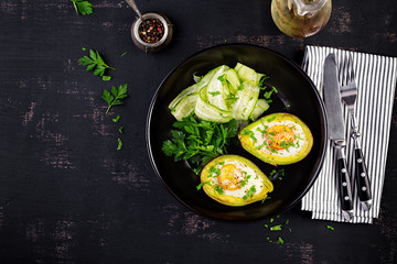 Avocado baked with egg and fresh salad. Vegetarian dish. Top view, overhead.  Ketogenic diet. Keto food