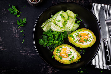 Avocado baked with egg and fresh salad. Vegetarian dish. Top view, overhead.  Ketogenic diet. Keto food