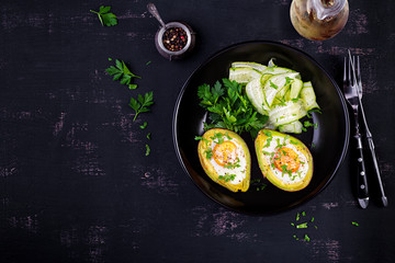 Avocado baked with egg and fresh salad. Vegetarian dish. Top view, overhead.  Ketogenic diet. Keto food
