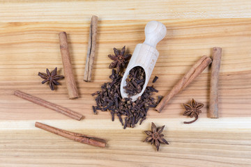 Top view of some dried spices on wooden surface