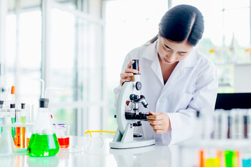 Positive delighted female scientist doing experiment