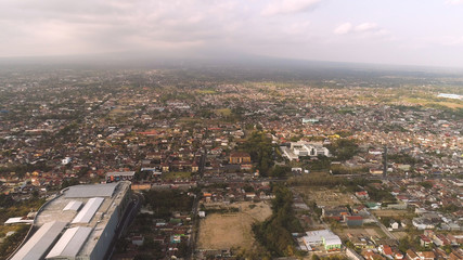 Fototapeta premium cityscape Yogyakarta with buildings, highway at sunset time. aerial view cultural capital Indonesia yogyakarta located on java island, Indonesia