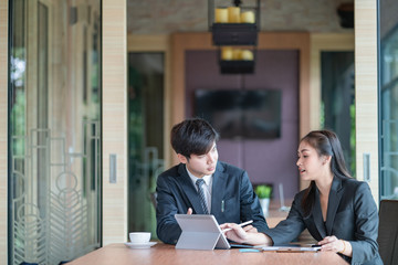 Team of business analysts discussing the business strategy in contemporary office room 